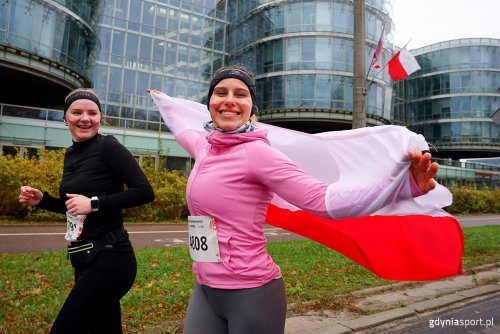 Biegnące kobiety z flagą Polski (fot. Jacek Klejment)