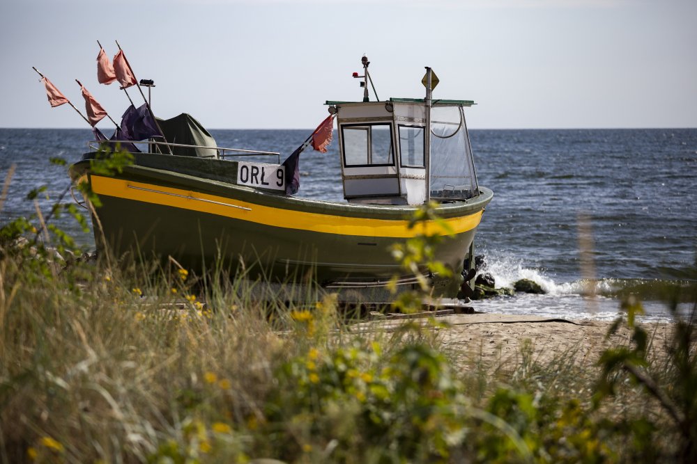 Przystań rybacka w Gdyni Orłowie, widok na kuter rybacki zacumowany na plaży