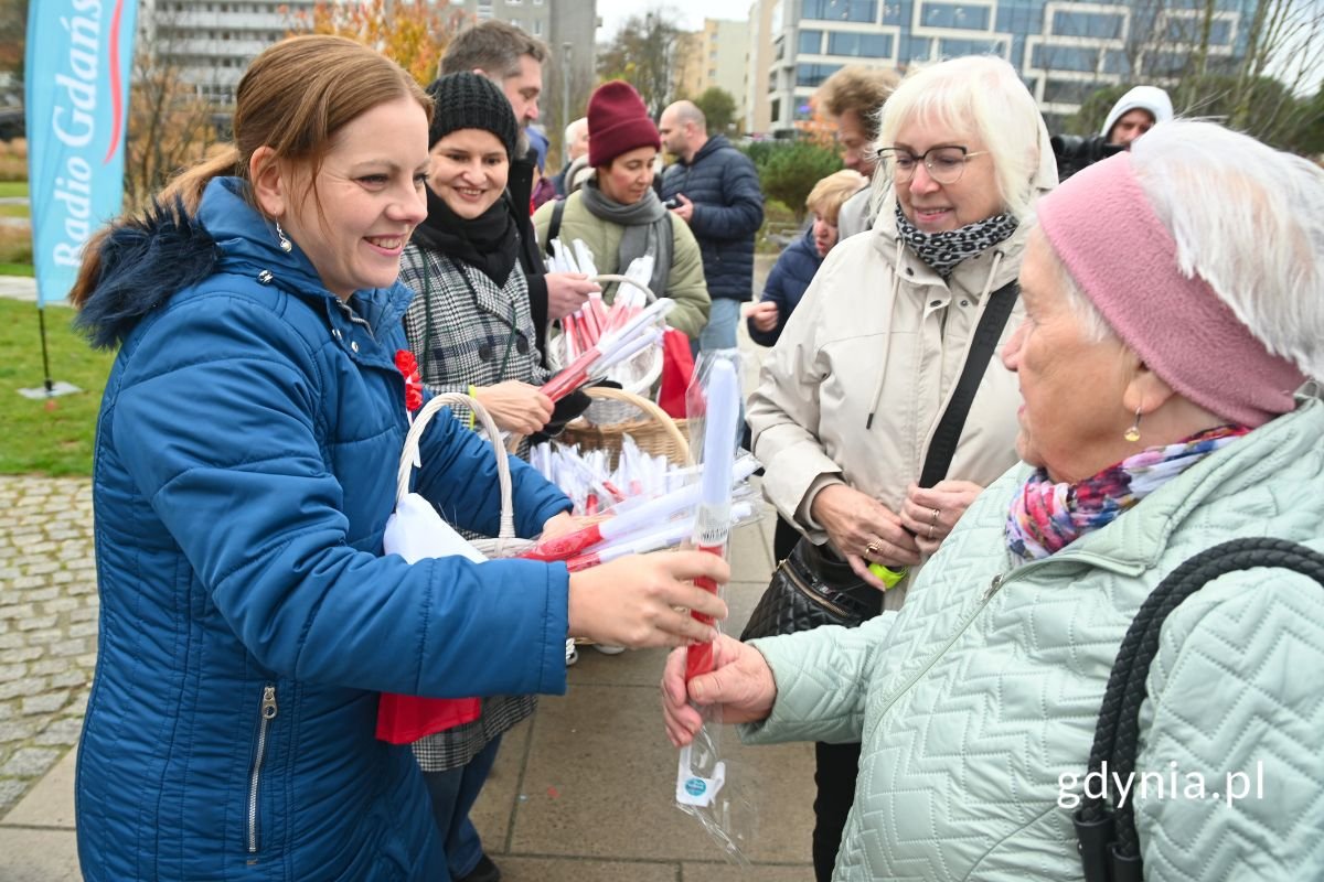  Prezydent Gdyni Aleksandra Kosiorek i przewodniczący Rady Miasta Tadeusz Szemiot rozdający gdynianom flagi (fot. Jakub Winiewski)