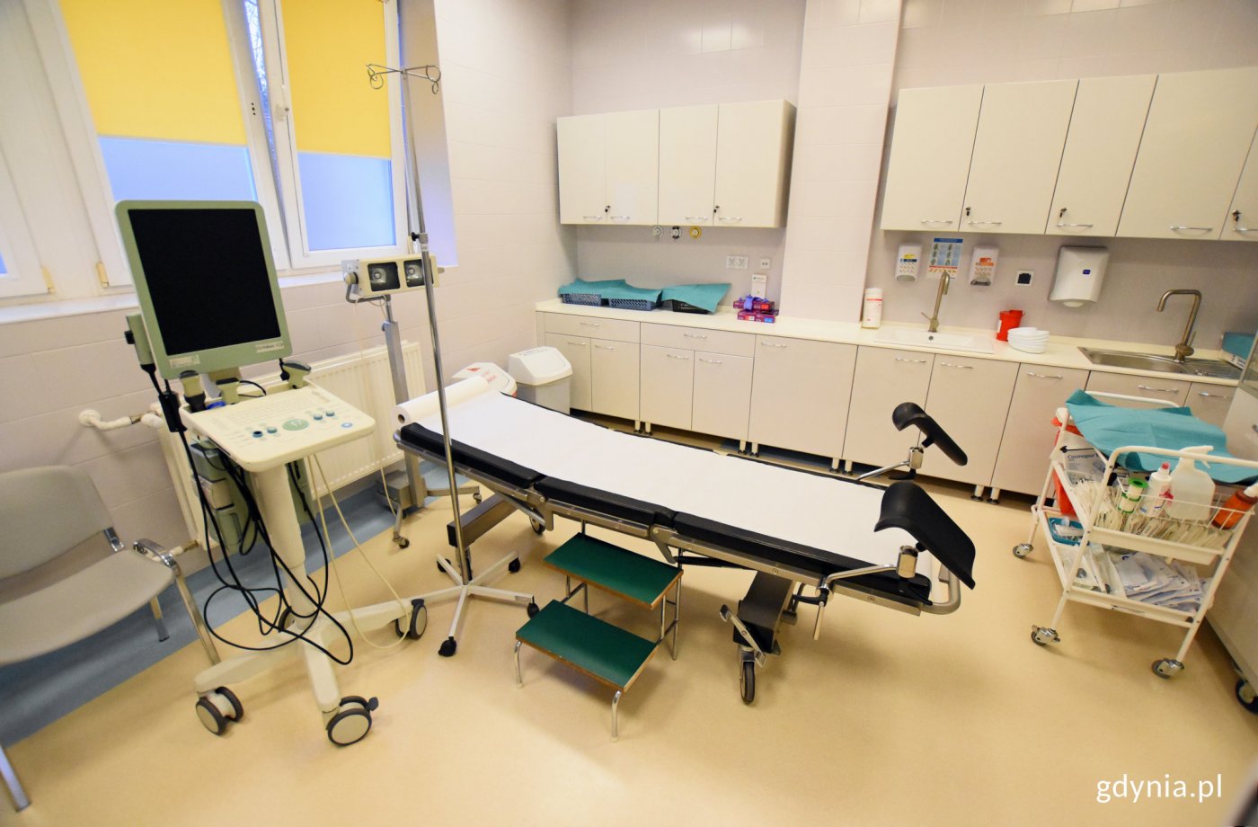 Wnętrze gabinetu lekarskiego na urologii, widoczne szafki, łóżko i sprzęt medyczny