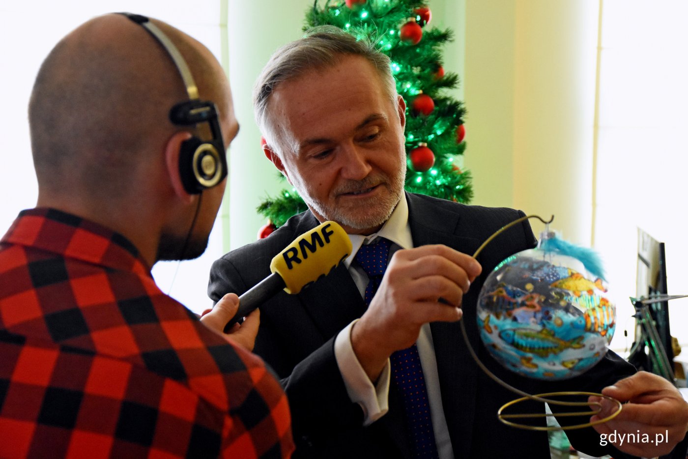 Prezydent Gdyni wojciech Szczurek przekazuje gotową bombkę reporterowi radia RMF FM. Trafi ona na charytatywną licytację w ramach świątecznej akcji radia RMF FM // fot. Kamil Złoch