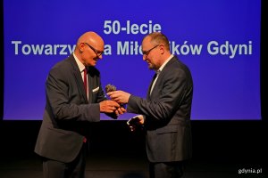 Statuetkę 50-lecia Towarzystwa Miłośnik&oacute;w Gdyni z rąk Wojciecha Kodłubańskiego &ndash; prezesa towarzystwa w imieniu prezydent Gdyni odebrał Mariusz Bzdęga &ndash; dyrektor zarządzający ds. kultury i aktywności mieszkańc&oacute;w