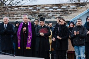 Grupa osób stoi na placu budowy.