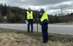 Dw&oacute;ch strażnik&oacute;w w mundurach przybija tabliczkę