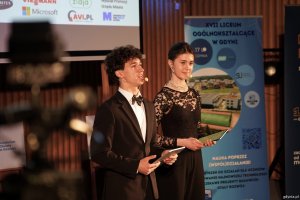 Chłopak i dziewczyna prowadzą uroczystość otwarcia 6. edycji konkursu Hackathon