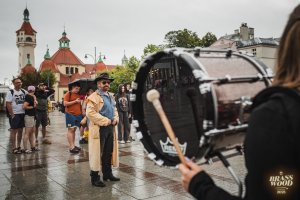 Mężczyzna w płaszczu, kobieta z bębnem