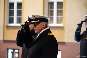 Kontradmirał prof. dr hab. Tomasz Szubrycht, rektor Akademii Marynarki Wojennej w Gdyni salutuje po złożeniu kwiatów