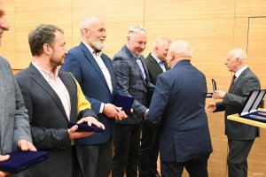 Mężczyźni w garniturach na scenie