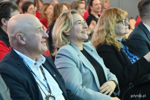 Na zdjęciu uśmiechnięci ludzie na widowni