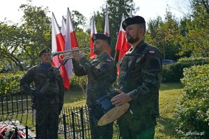 Trębacz i werblista oraz żołnierz stojący na posterunku honorowym przy Obelisku Obrońc&oacute;w Kępy Oksywskiej na Babich Dołach podczas uroczystości z okazji 87. rocznicy zakończenia walk w obronie Kępy Oksywskiej