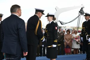 Kobieta marynarz dostaje od dowódcy kordzik.