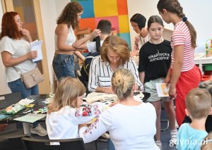 Grupa ludzi na warsztatach z malowania toreb