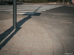 na pierwszy planie widoczny nowy chodnik z kostki, w tle przejście dla pieszych