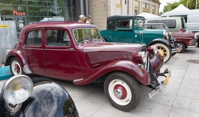 Zabytkowe auto stojące na wystawie, w tle budynek