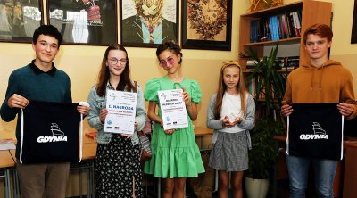 Na zdjęciu piątka młodzieży (troje dziewcząt i dwoje chłopców) uśmiecha się do kadru