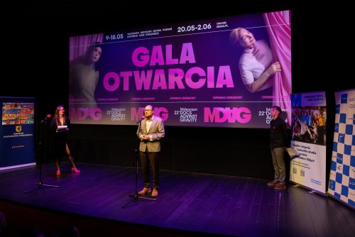 Mariusz Bzdęga, dyrektor zarządzający ds. kultury i aktywności mieszkańców, przemawiający podczas gali otwarcia 22. edycji Millennium Docs Against Gravity. Na scenie wraz z nim prowadzący wydarzenie Przemysław Rydzewski oraz Krystyna Weiher-Sitkiewicz (fot. Anna Rezulak)