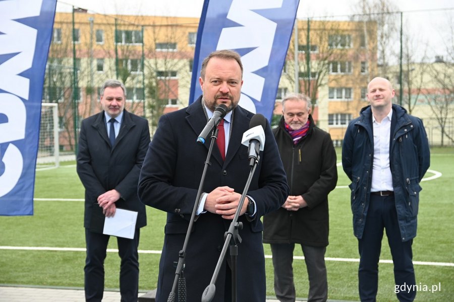 Przemawiający wiceprezydent, w tle pozostali oficjele i boisko