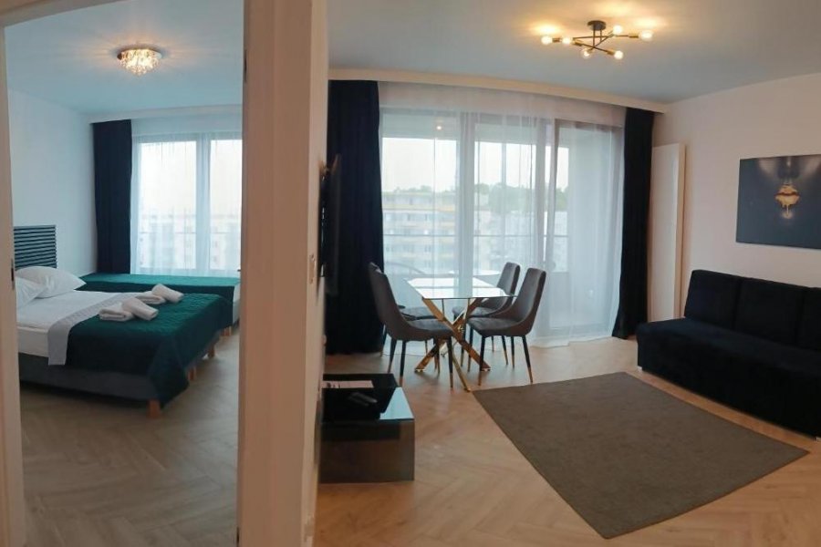 Sypialnia i salon w obiekcie Sleepy3city - Apartamenty Plac Unii