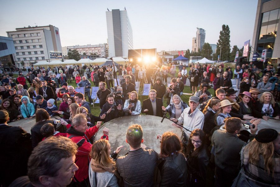 Goście festiwalu NNW 2023 wypowiadający się podczas panelu. Znajdują się na placu Grunwaldzkim w Gdyni, w tle - tłum ludzi i wysokie budynki. 