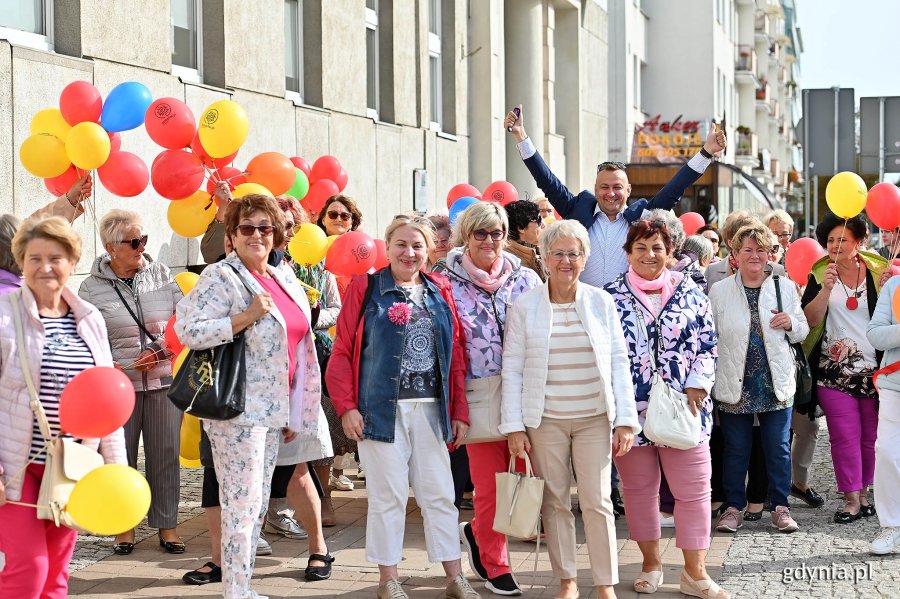 Uczestnicy marszu z kolorowymi balonami w rękach oraz Kordian Kulaszewicz - prezes Fundacji Adaptacja przed Urzędem Miasta Gdyni 