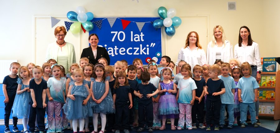 Dzieci w kolorowych strojach z nauczycielami