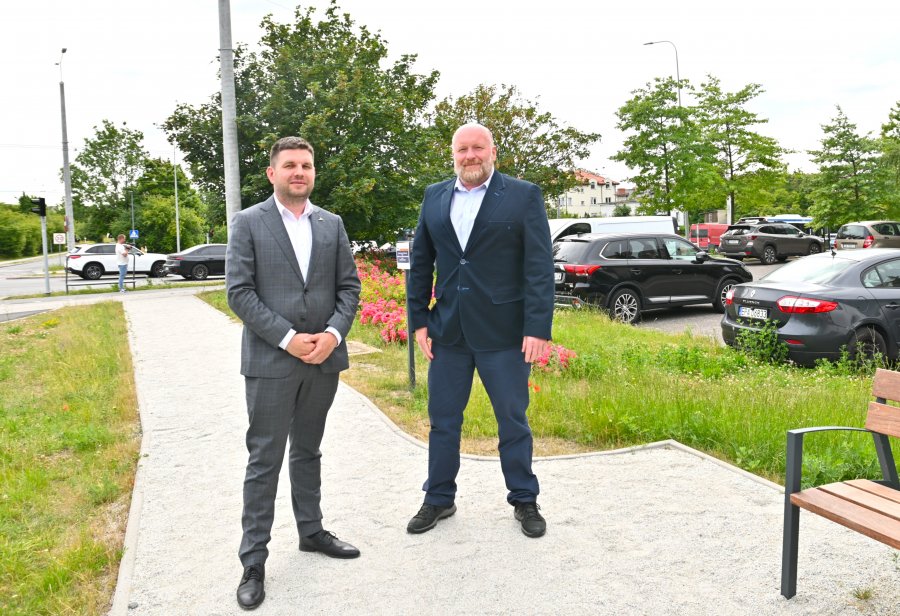 Dwaj mężczyźni w garniturach na tle zieleni