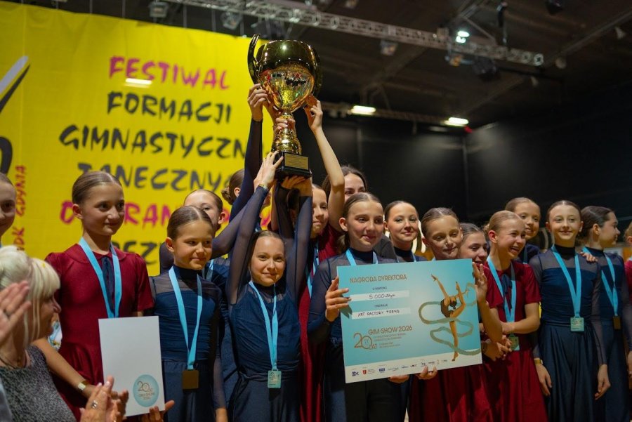 Kolorowo ubrane dziewczynki z medalami i pucharem