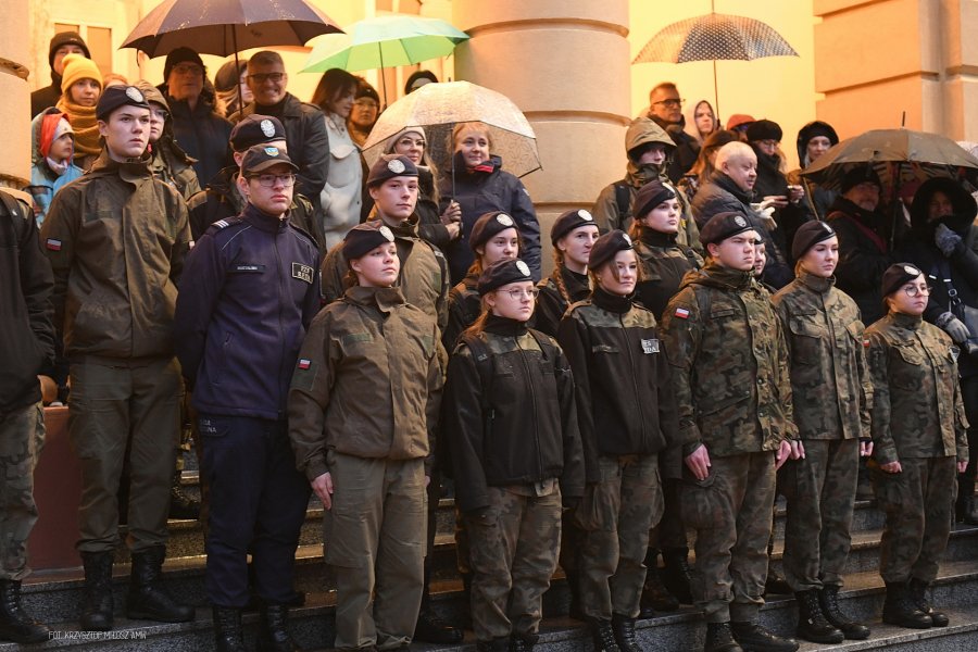 Uczniowie uczelni wojskowej z wmundurach moro stoją na schodach.