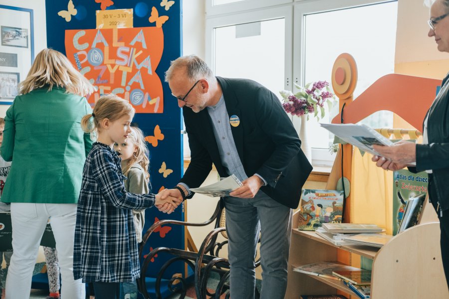 Wiceprezydent Michał Guć wita się z uczennicą Szkoły Podstawowej nr 45