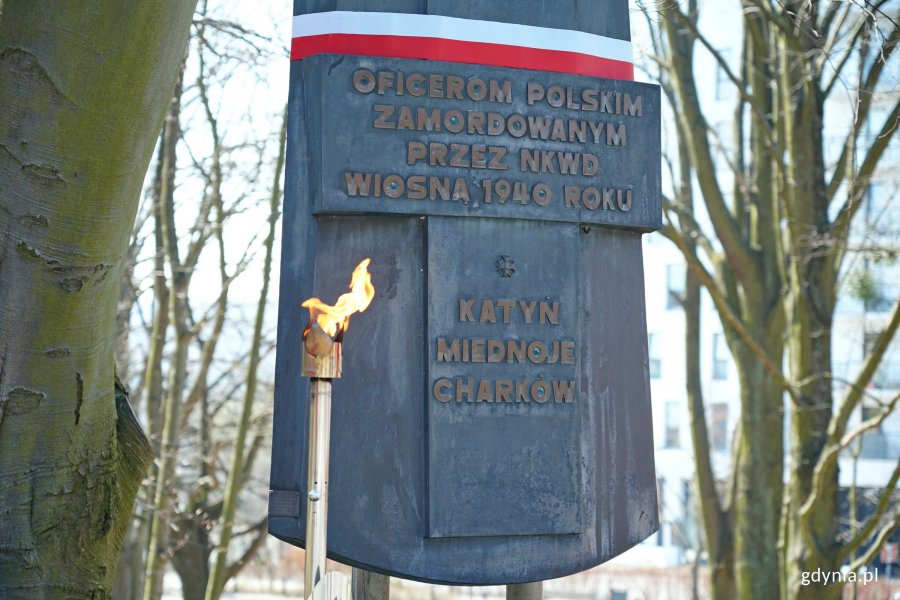 Pomnik Ofiar Katynia na Cmentarzu Wojennym w Redłowie i palący się z okazji uroczystości znicz