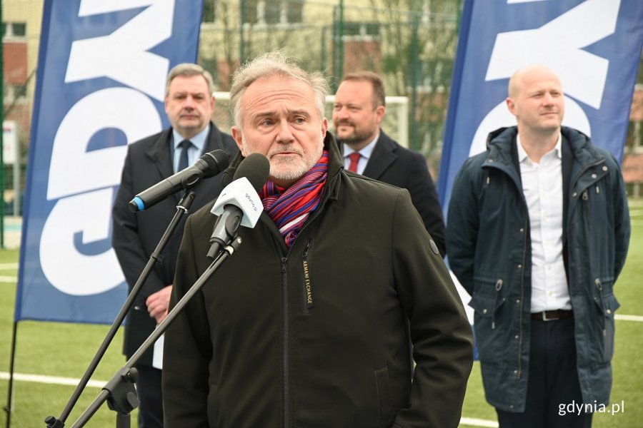 Przemawiający prezydent, w tle pozostali oficjele i boisko