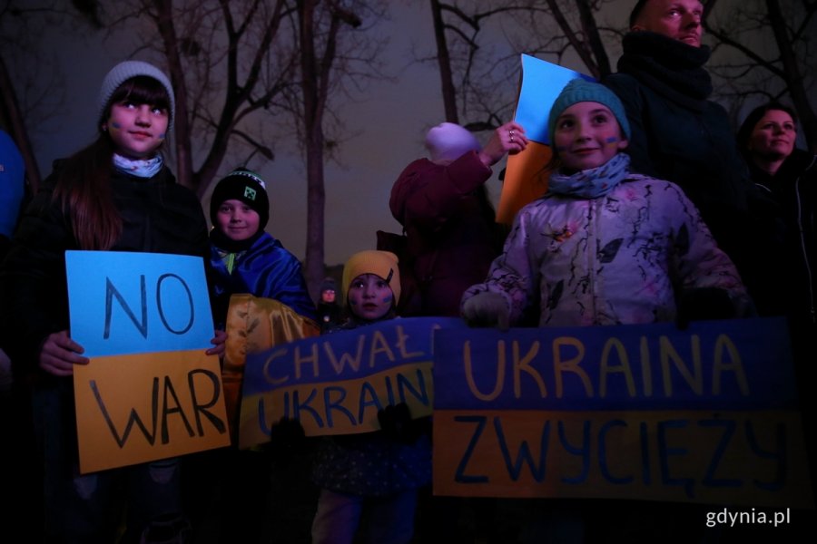 Mieszkańcy Gdyni, wśród nich dzieci, zgromadzeni wieczorem przed budynkiem Urzędu Miasta Gdyni protestują przeciw wojnie w Ukrainie trzymając antywojenne hasła.