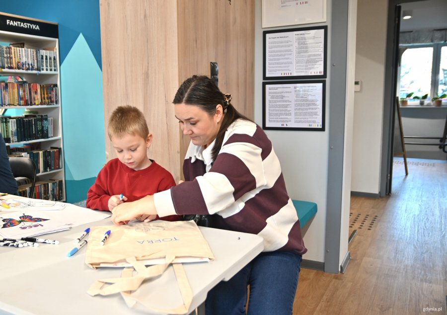 Kobieta z chłopcem malują torby