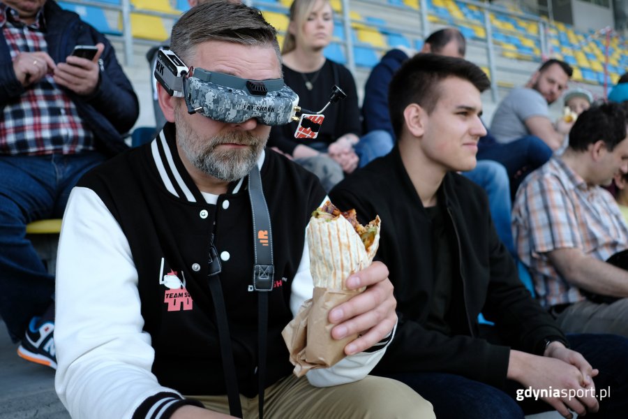 Kibic siedzi na trybunie w okularach VR
