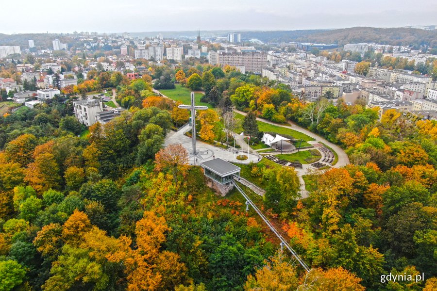 Widok z lotu ptaka na jesienną Kamienną Górę. W centrum zdjęcia krzyż i park im. Marii i Lecha Kaczyńskich. W tle okoliczne bloki // fot. Michał Puszczewicz