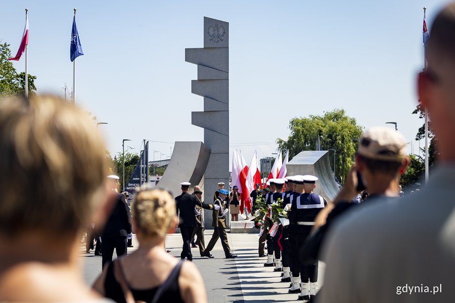 Marynarze z wieńcami pod pomnikiem.
