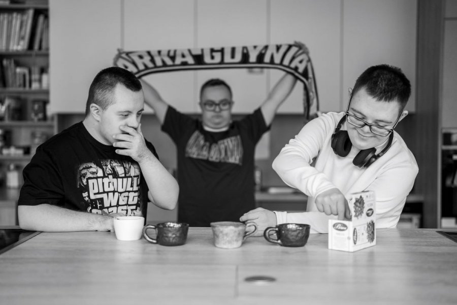 Trzech męzczyzn, jeden z szalikiem Arki Gdynia