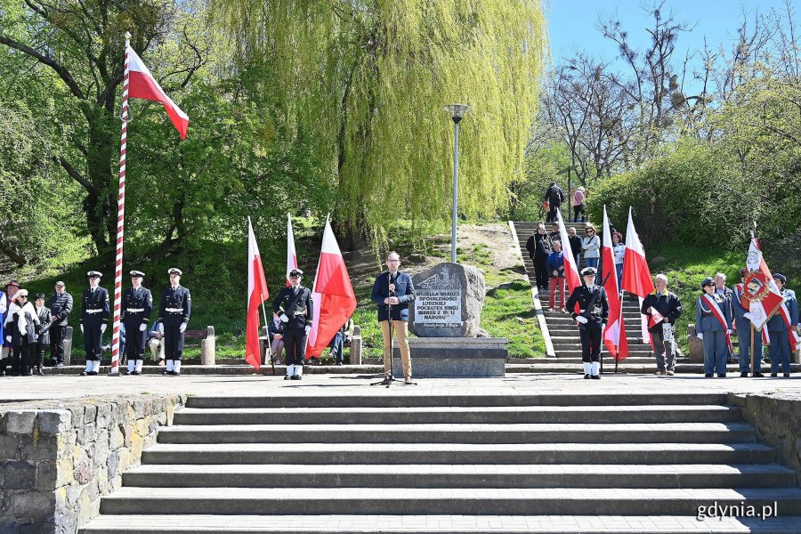 Na środku: Jakub Ubych - wiceprzewodniczący Rady Miasta Gdyni przemawiający podczas uroczystości z okazji Narodowego Święta Konstytucji 3 Maja. Za nim posterunek honorowy przy pomniku Konstytucji 3 Maja, poczet flagowy i poczty sztandarowe uczestniczące w wydarzeniu // fot. Michał Puszczewicz