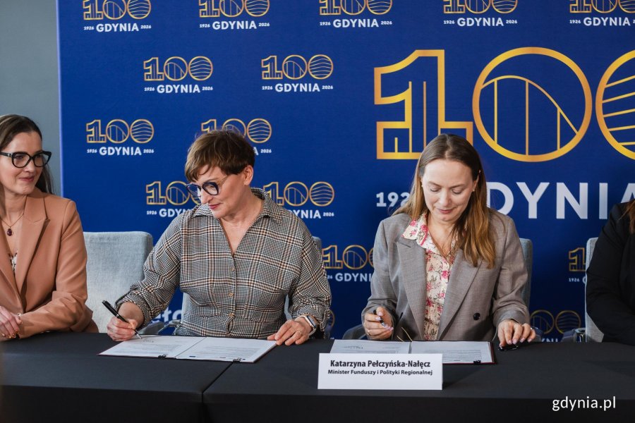 Grupa ludzi podpisująca umowę o dofinansowanie