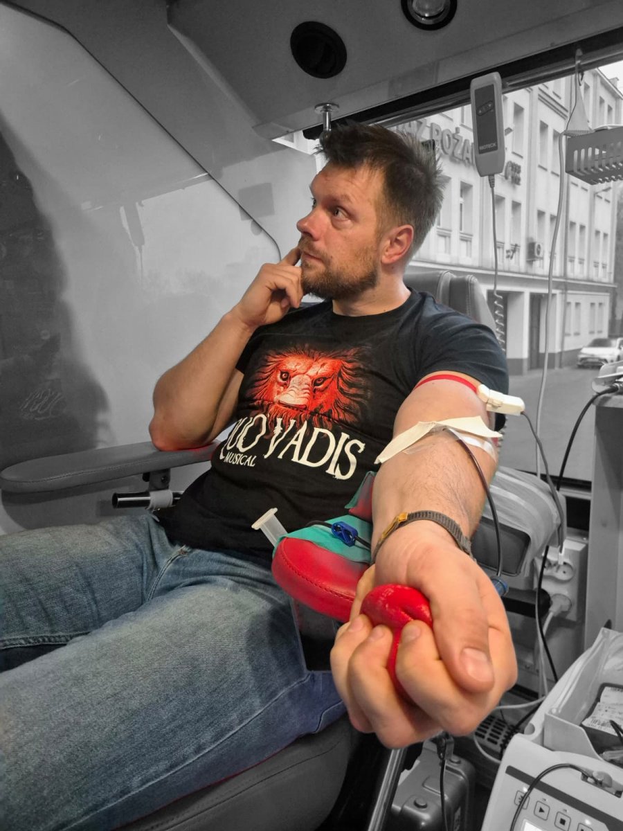 Męzczyzna oddaje krew, ma koszulkę z motywem Quo vadis