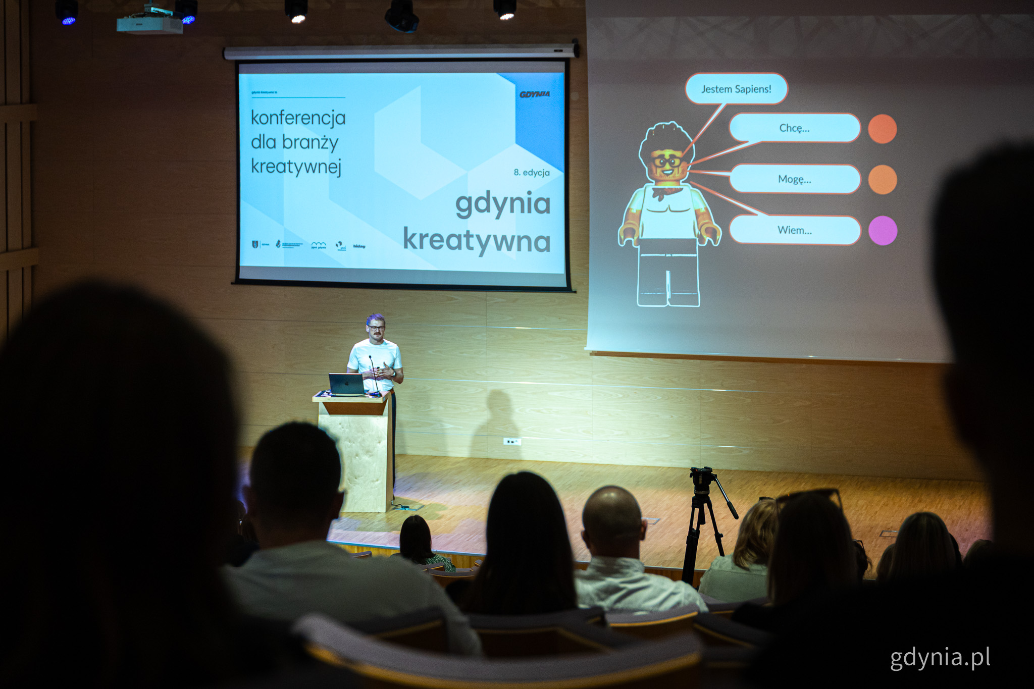 Sala konferencyjna PPNT Gdynia, prezentacja na ekranie, Piotr Bucki prowadzi wykład, widoczni ludzie na widowni