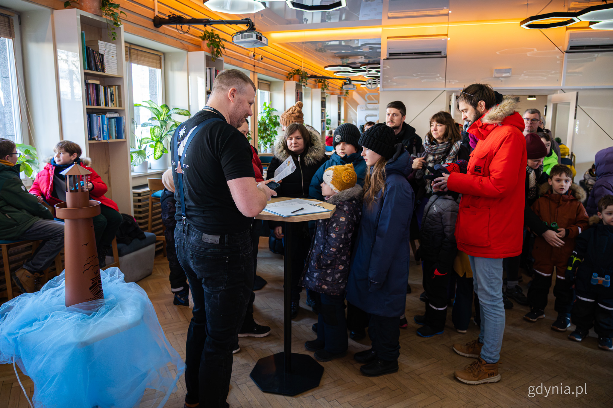 Sala w Konsulacie Kultury, tłum ludzi, widoczna makieta latarni morskiej