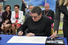 Ks. Grzegorz Miloch podpisuje akt erekcyjny budowy stacjonarnego hospicjum dla dzieci w Gdyni, fot. Dorota Nelke