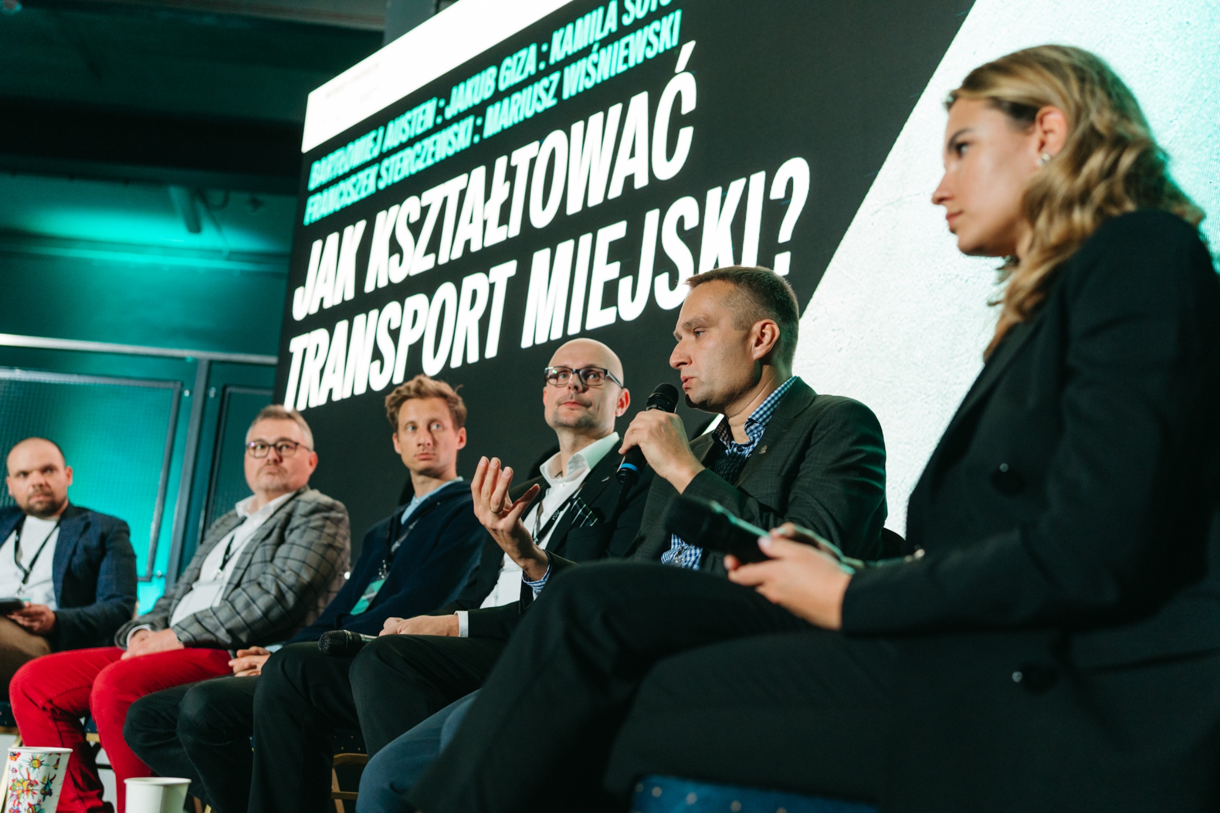 Uczestnicy debaty „Jak kształtować transport miejski?” (od prawej): Kamila Sotomska – liderka ds. polityki publicznej, CEE z Ubera, Mariusz Wiśniewski – zastępca prezydenta Poznania, Bartłomiej Austen – wiceprezydent Gdyni, Franciszek Sterczewski – poseł z Koalicji Obywatelskiej i Jakub Giza – dyrektor ds. rozwoju systemów rowerowych. Po lewej: Roch Kowalski – dziennikarz Polskiego Radia (fot. Zuza Balcerzak) 