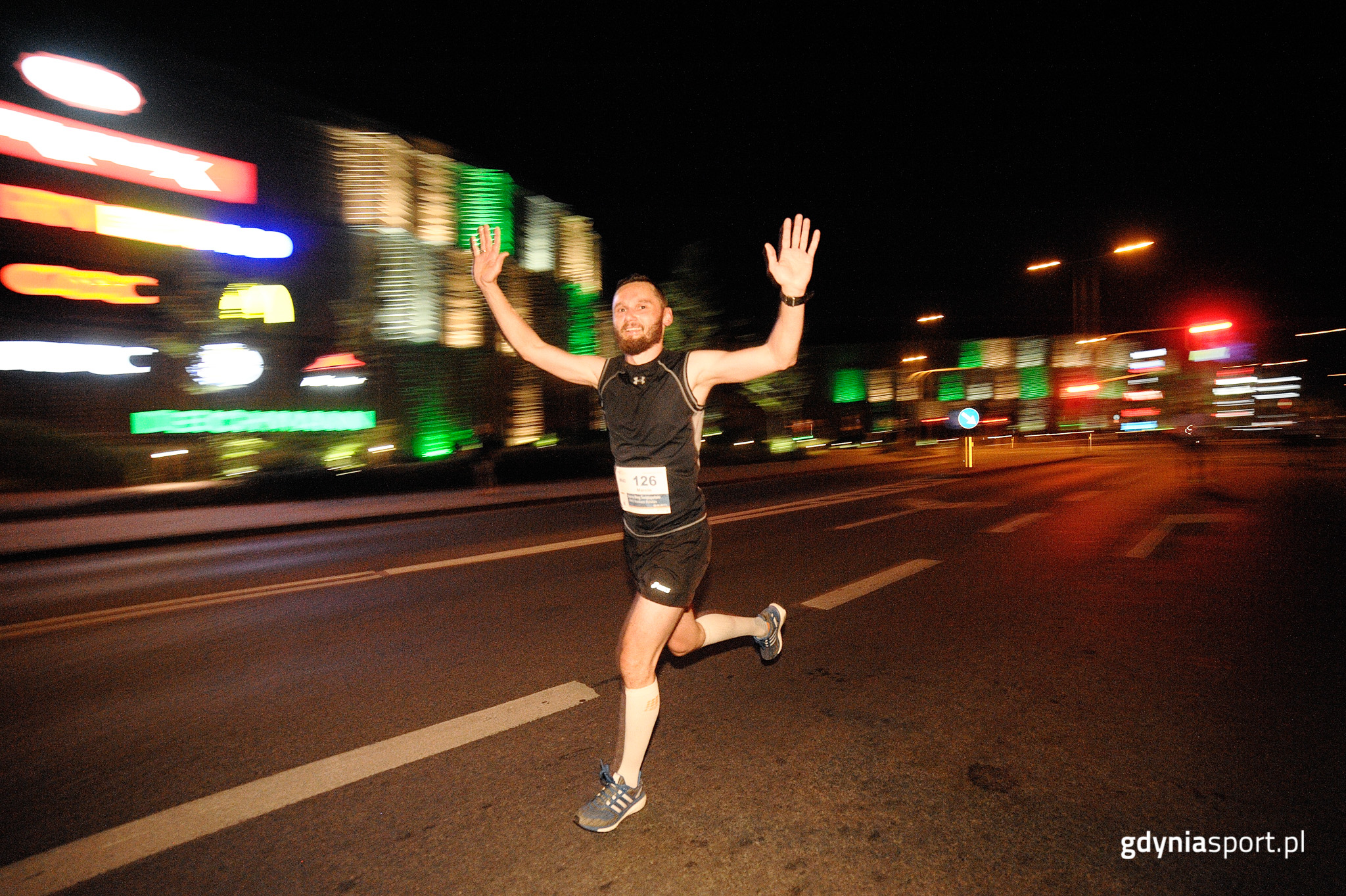 Uśmiechnięty biegacz podczas Nocnego Biegu Świętojańskiego w Gdyni