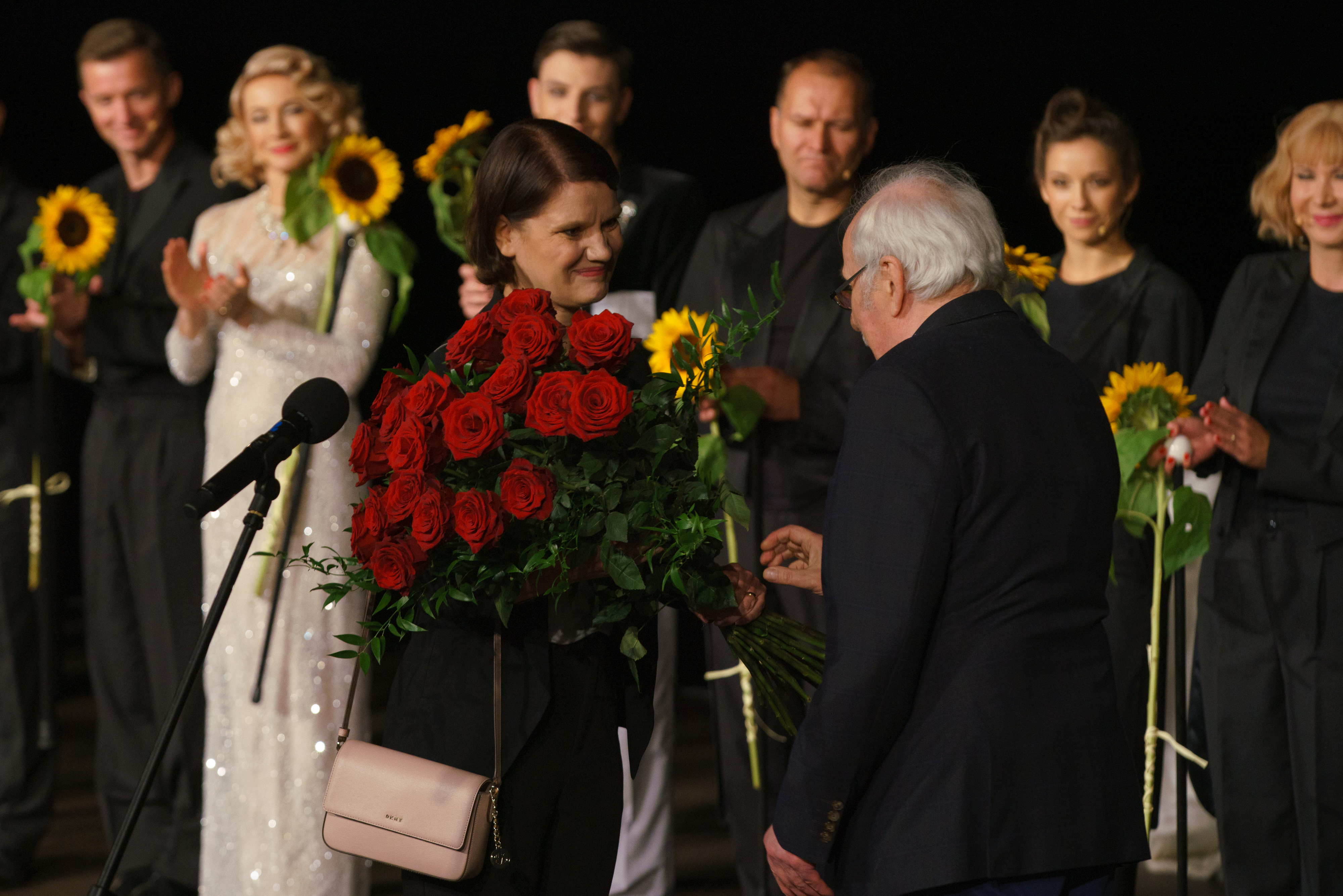 Wiceprezydent Gdyni Katarzyna Gruszecka-Spychała wręcza kwiaty Wojciechowi Zielińskiemu - przechodzącemu na emeryturę wieloletniemu dyrektorowi Teatru Miejskiego. W tle aktorzy teatru // fot. Anna Rezulak