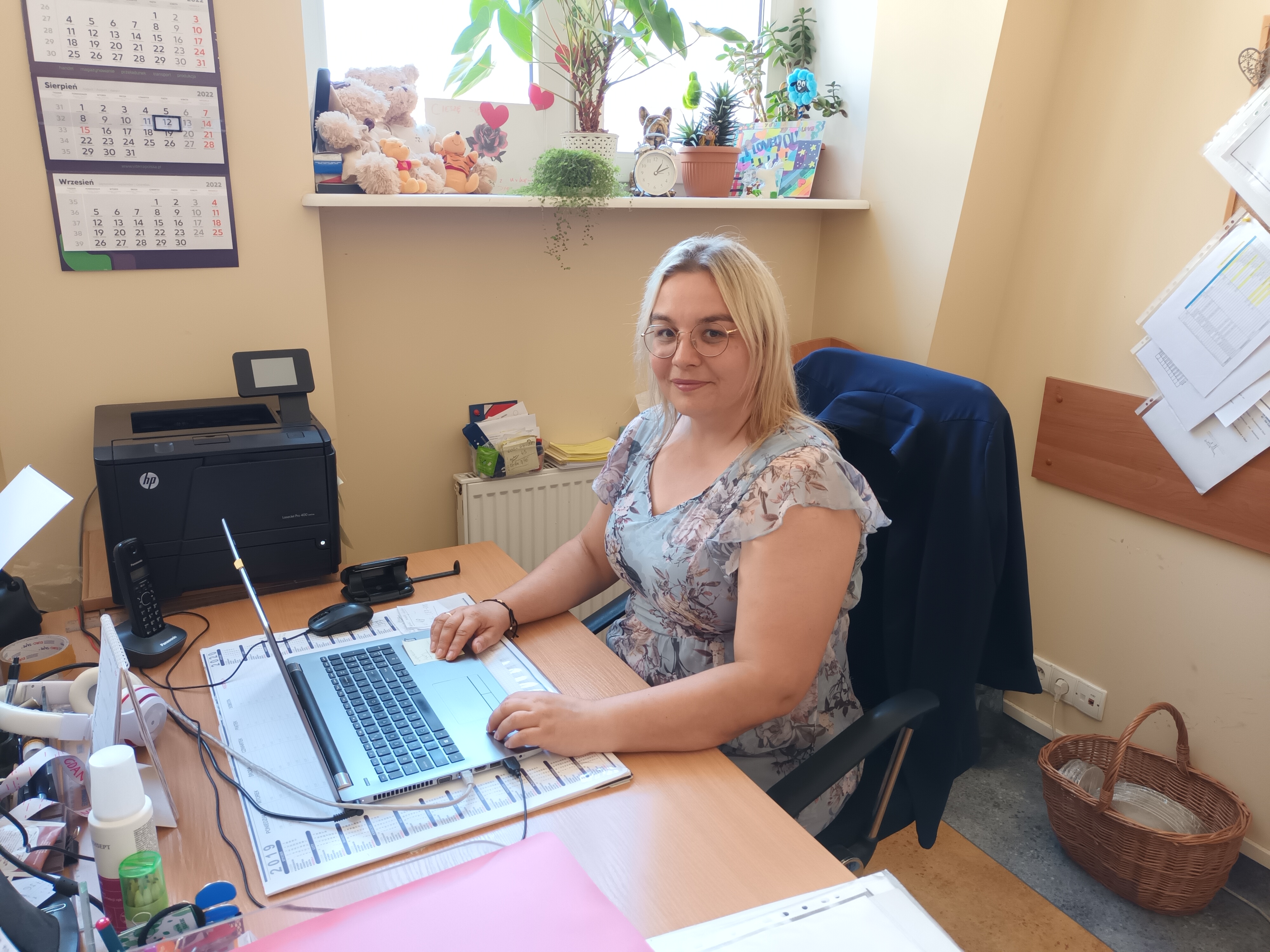 Młoda kobieta siedzi przy biurku 