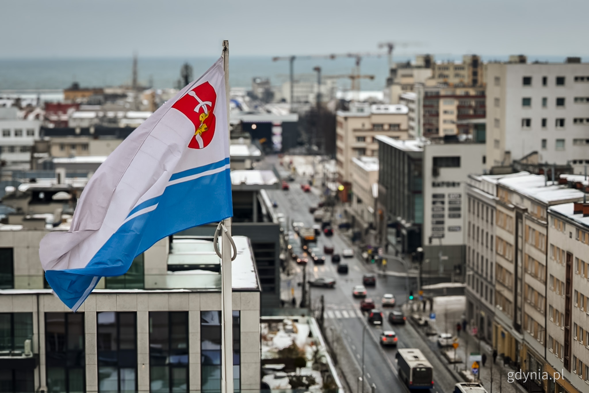na zdjęciu flaga Gdyni nad budynkami