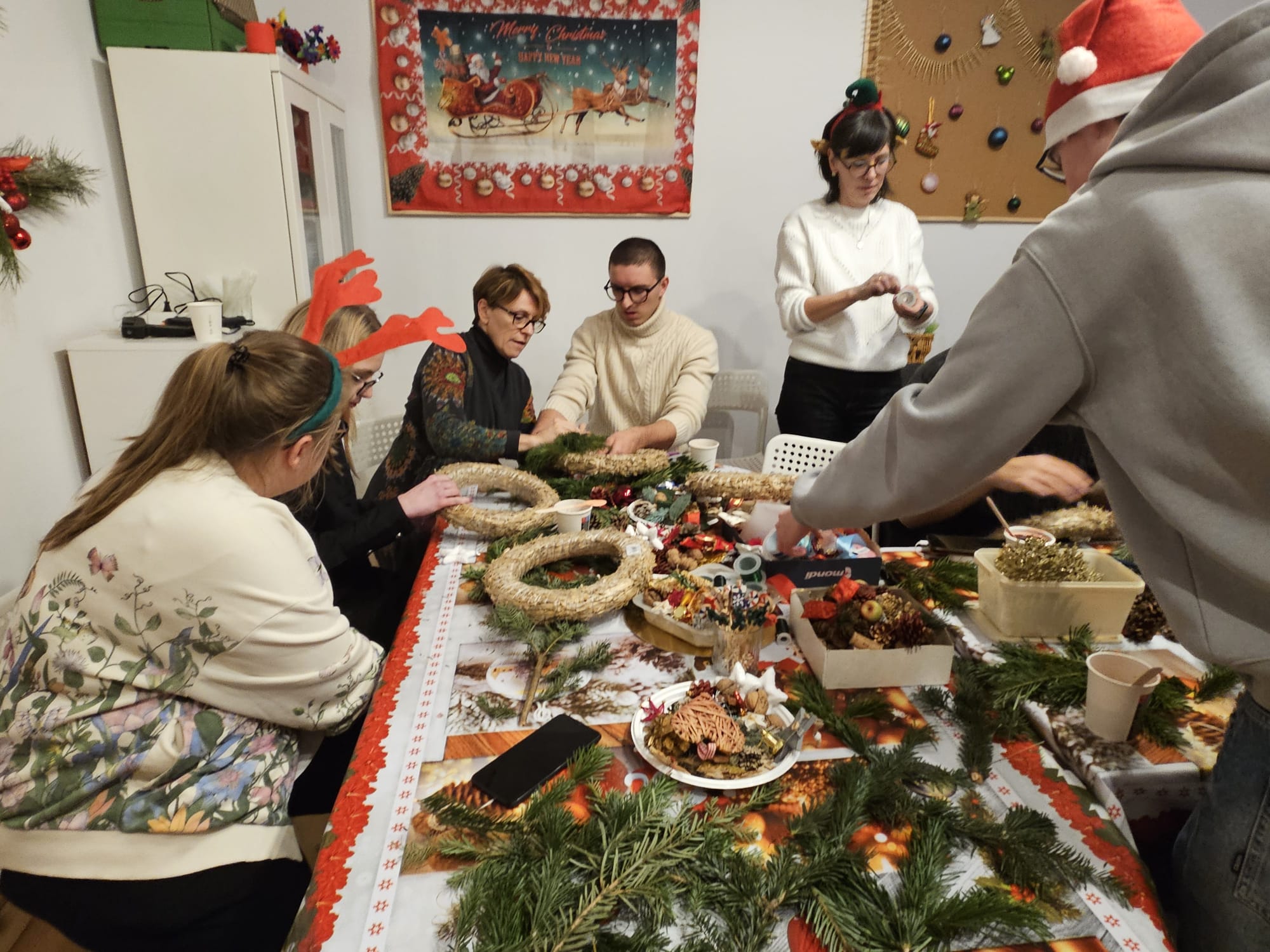 grupa udzi w r&oacute;żnym wieku na świątecznych warsztatach manualnych 