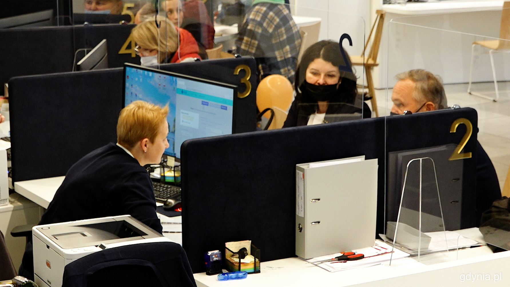 Prezydent Gdyni, Wojciech Szczurek (z prawej) przy jednym ze stanowisk przeznaczonych do obsługi os&oacute;b z Ukrainy w Centrum Obsługi Mieszkańca, fot. Marcin Mielewski